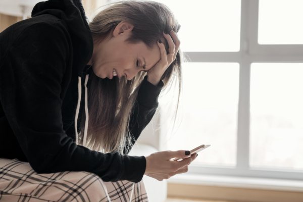 woman-holding-phone-crying